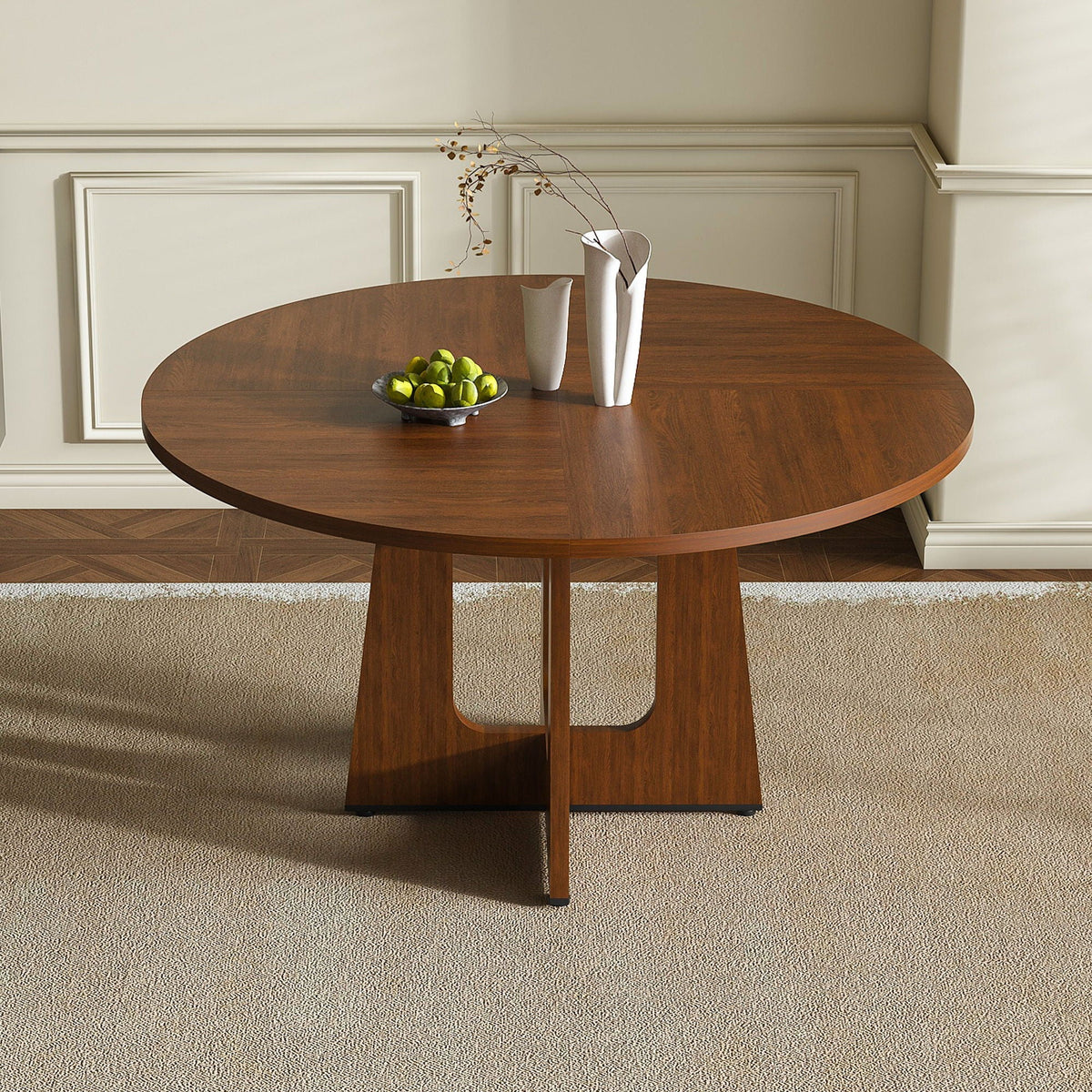 Round dining table for 4 in dark brown wood with pedestal base and white vases on beige walls on Tampa Home & Garden Store