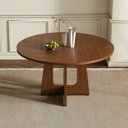 Round dining table for 4 in dark brown wood with pedestal base and white vases on beige walls on Tampa Home & Garden Store