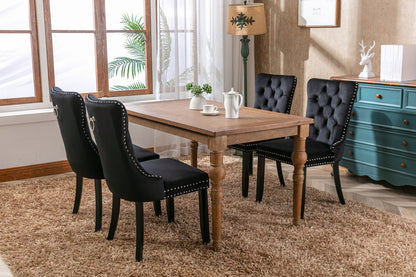Tufted dining chair set in black velvet with nailhead trim around a table HouseOfZazla on Tampa Home & Garden Store