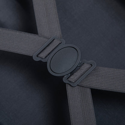Luggage strap close-up on dark fabric showing gray woven strap and plastic buckle on Tampa Home & Garden Store