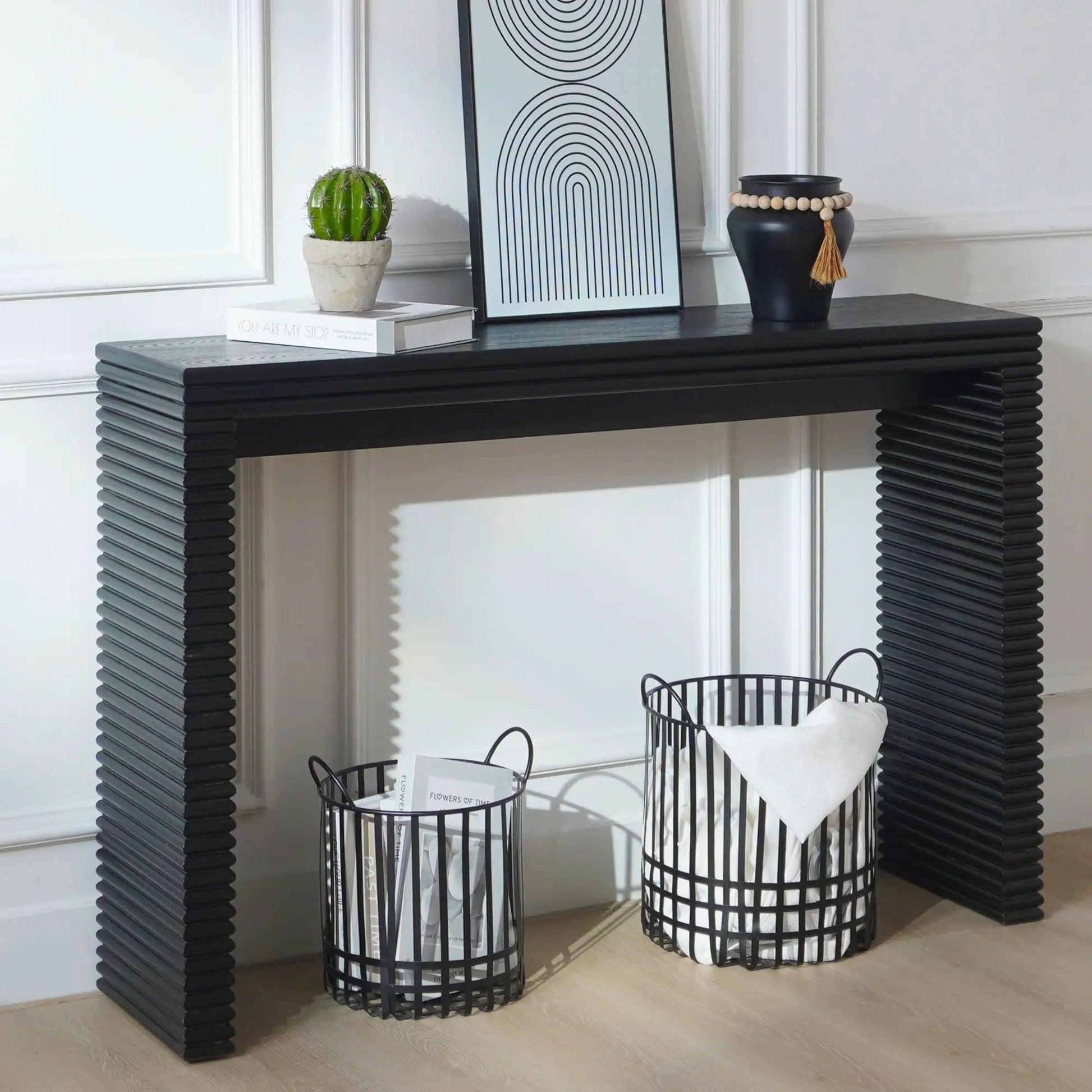 Modern console table with ribbed black legs, potted cactus, framed abstract print, beaded vase decor on Tampa Home & Garden Store