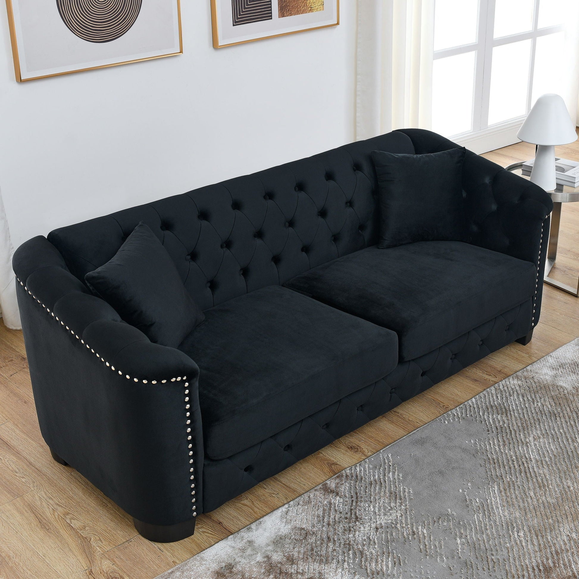 Modern Chesterfield sofa with tufted backrest, black upholstery, nailhead trim, stationary seating on Tampa Home & Garden Store
