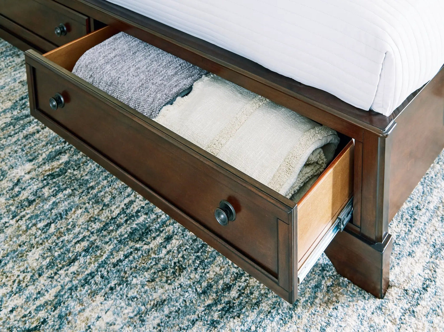 Trellington Queen Sleigh Storage Bed in Brown