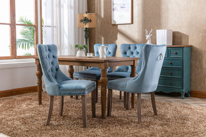 Tufted velvet dining chair set in blue with nailhead trim, four chairs around a wooden table on Tampa Home & Garden Store
