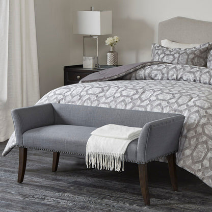 Elegant upholstered bench with a solid wood frame in gray fabric at bed with nailhead trim on Tampa Home & Garden Store