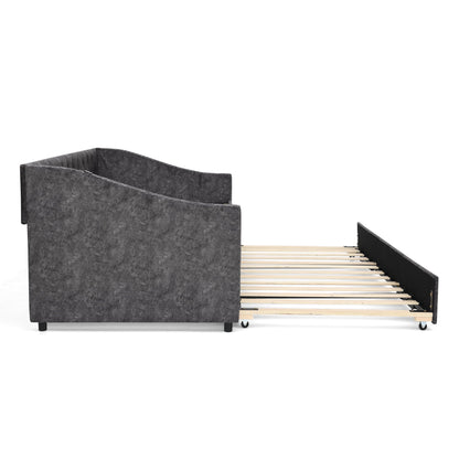 Upholstered daybed with curved back in dark gray fabric and a pull-out bed on slats on Tampa Home & Garden Store