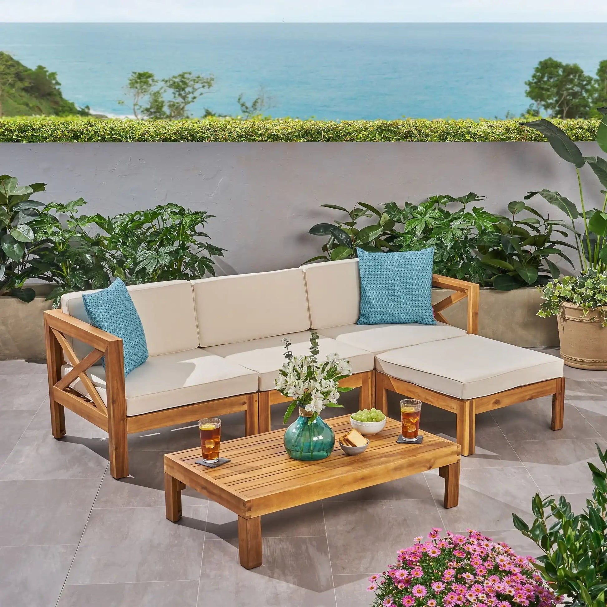 Alcove L Shape Sofa Set 2-piece outdoor sectional with natural wood frame, beige cushions, blue pillows on Tampa Home & Garden Store