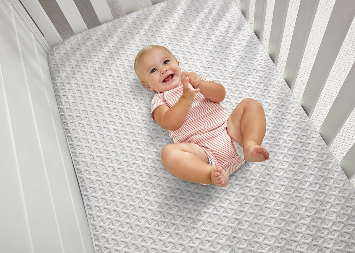 Bed Gear Ver-Tex Crib Mattress Protector, gray quilted protector with a baby in a striped onesie on Tampa Home & Garden Store