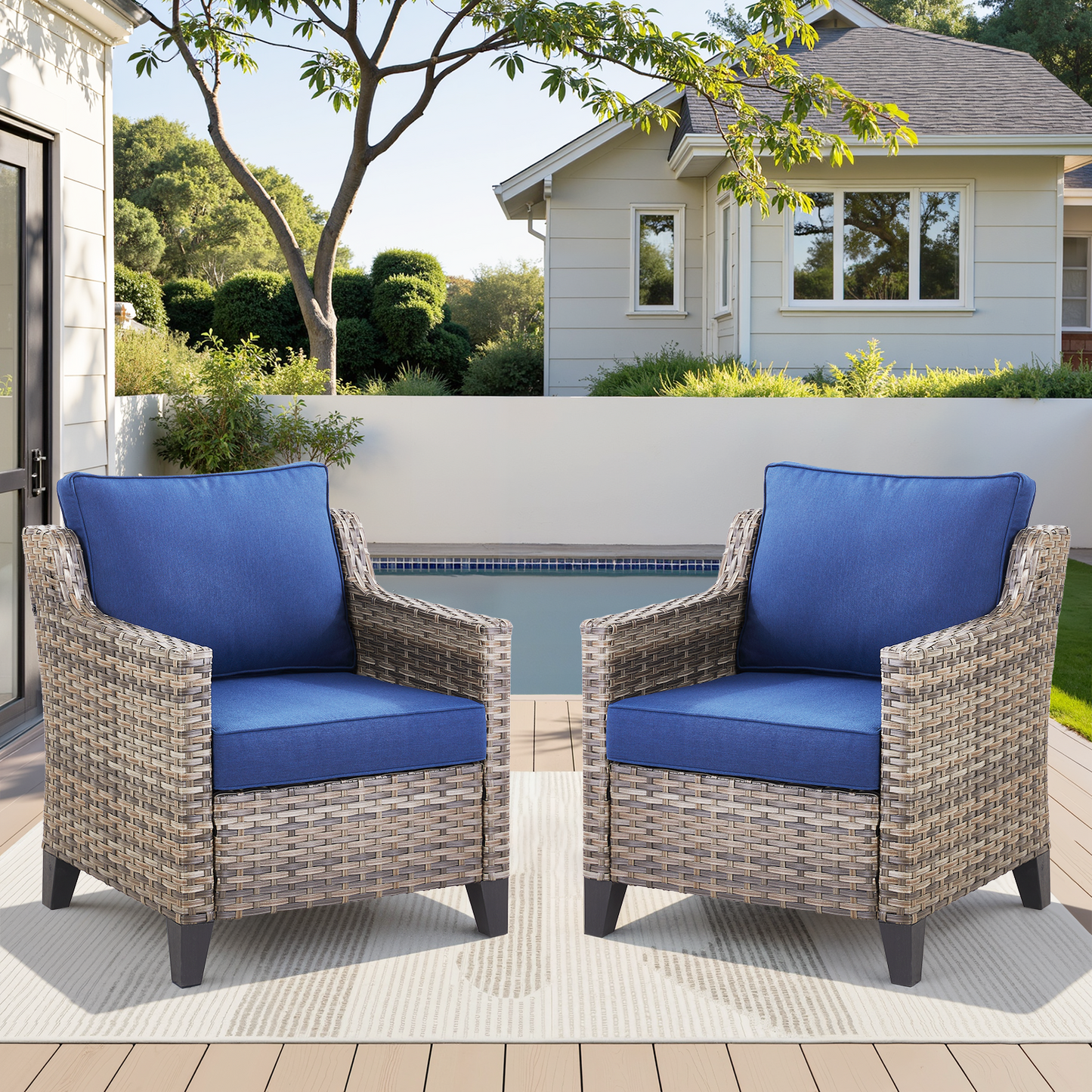 Outdoor patio arm chairs set of 2 with blue cushions and woven wicker frames on a poolside deck on Tampa Home & Garden Store