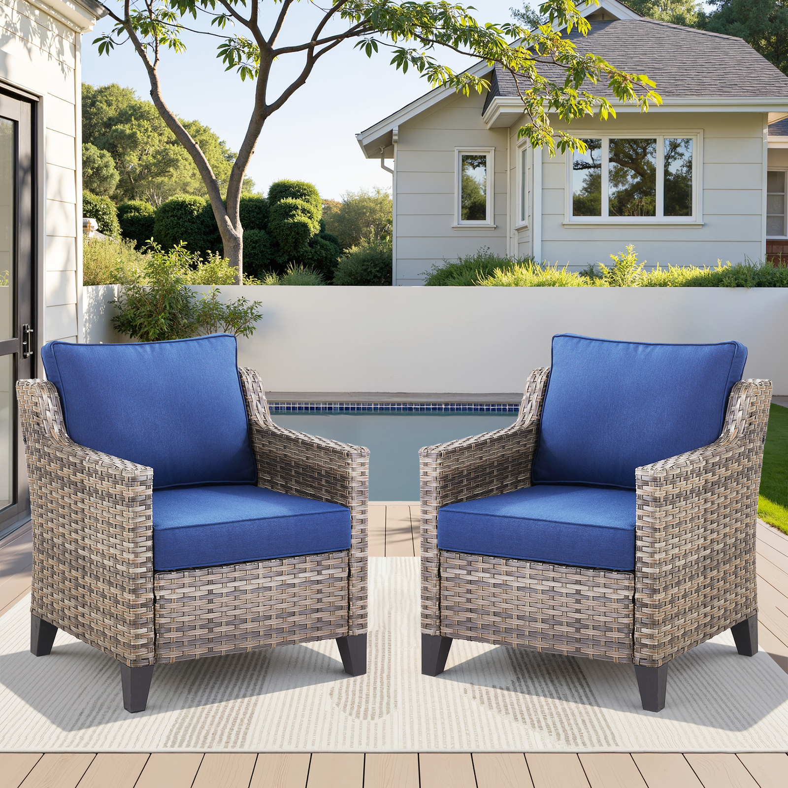 Outdoor patio arm chairs set of 2 with blue cushions and woven wicker frames on a poolside deck on Tampa Home & Garden Store