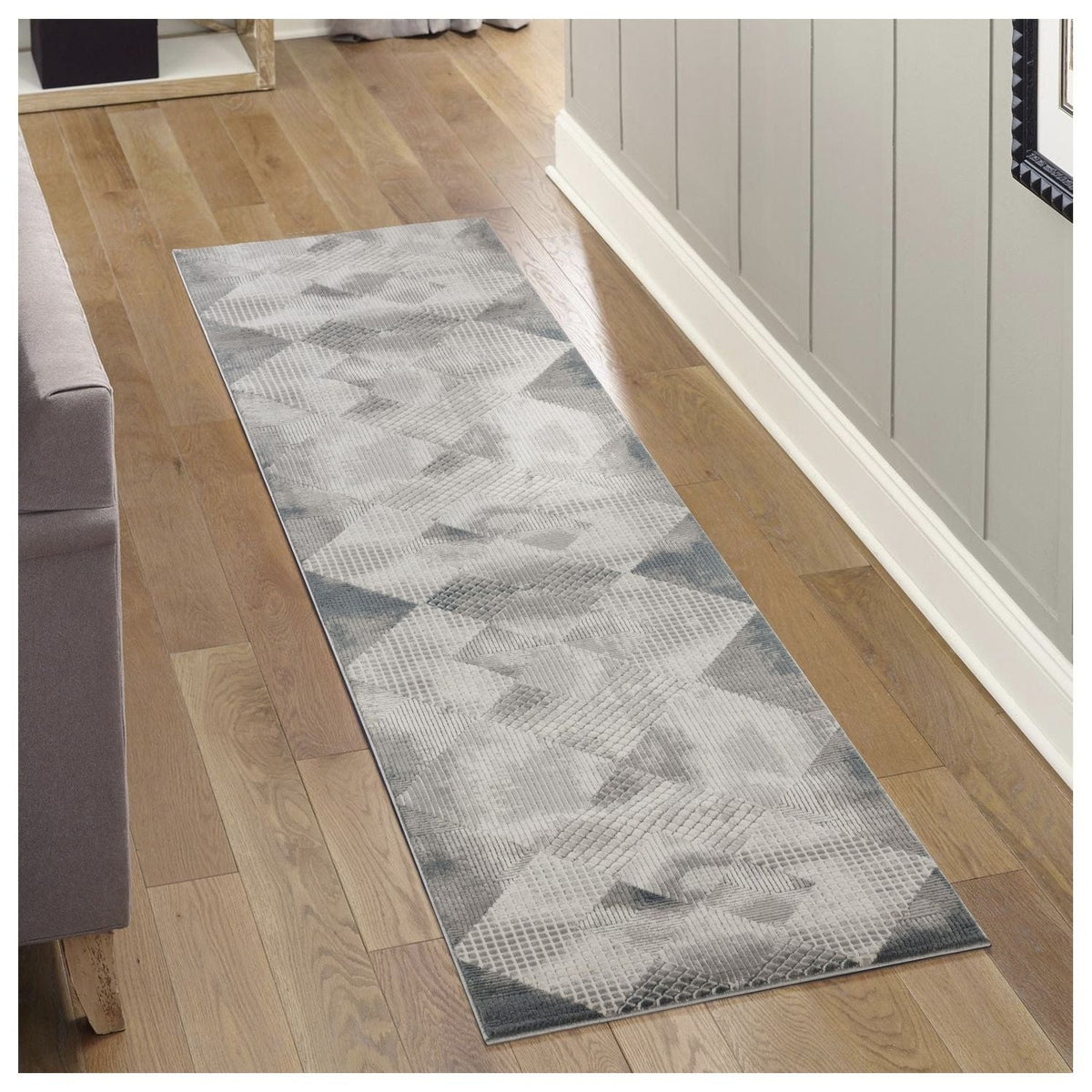Soft 3D gray geometric area rug runner with layered triangle patterns on wood floor on Tampa Home & Garden Store