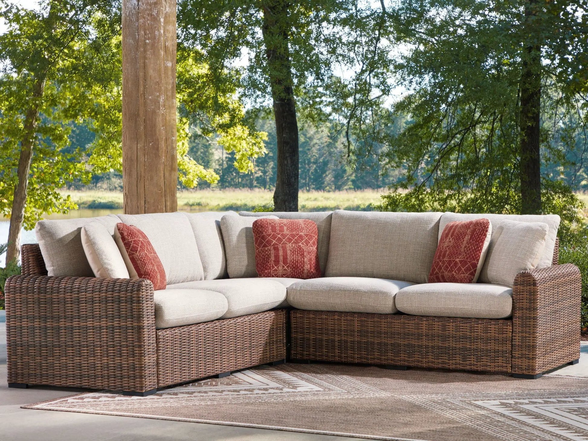 Dolan Creek outdoor sectional by Unique Piece Furniture, tan cushions, red accents, wicker on Tampa Home & Garden Store