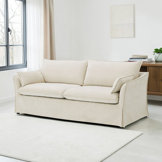 Shane sofa with 2 beige pillows, beige fabric upholstery in a bright living room on Tampa Home & Garden Store