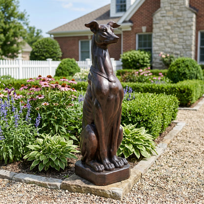 Greyhound dog statue with bronze finish in a landscaped garden on Tampa Home & Garden Store