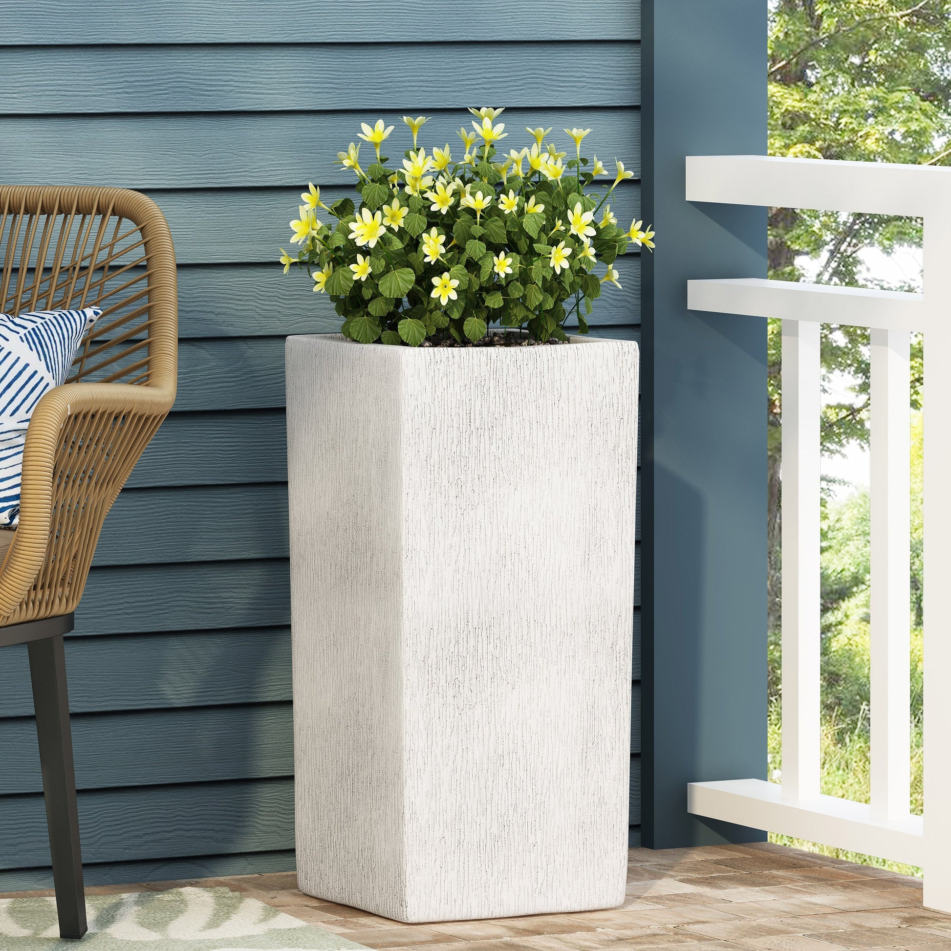 MGO Planter by HouseOfZazla, gray textured planter with yellow flowers on blue siding patio on Tampa Home & Garden Store