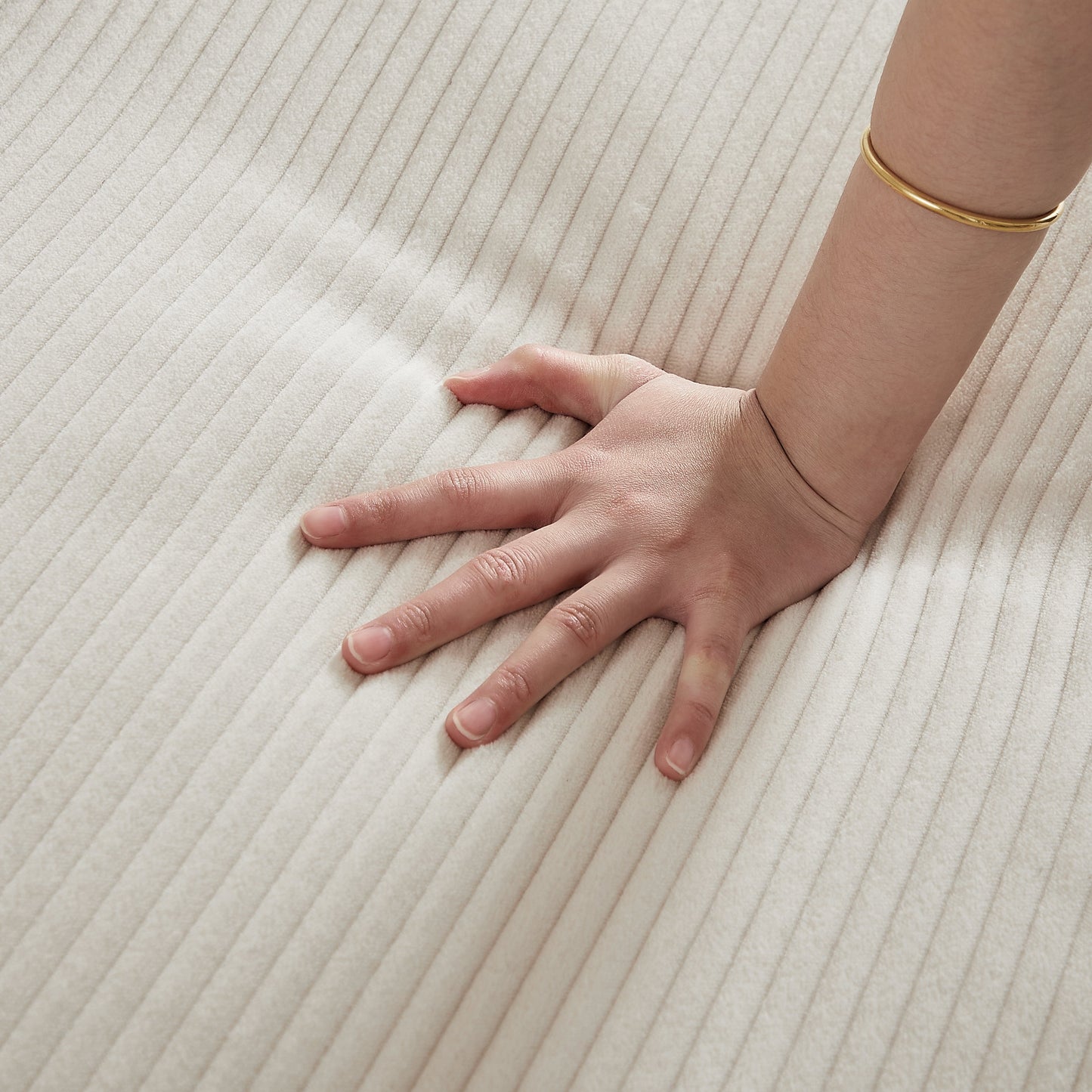 Beige corduroy fabric close-up with a wrist wearing a gold bracelet on Tampa Home & Garden Store