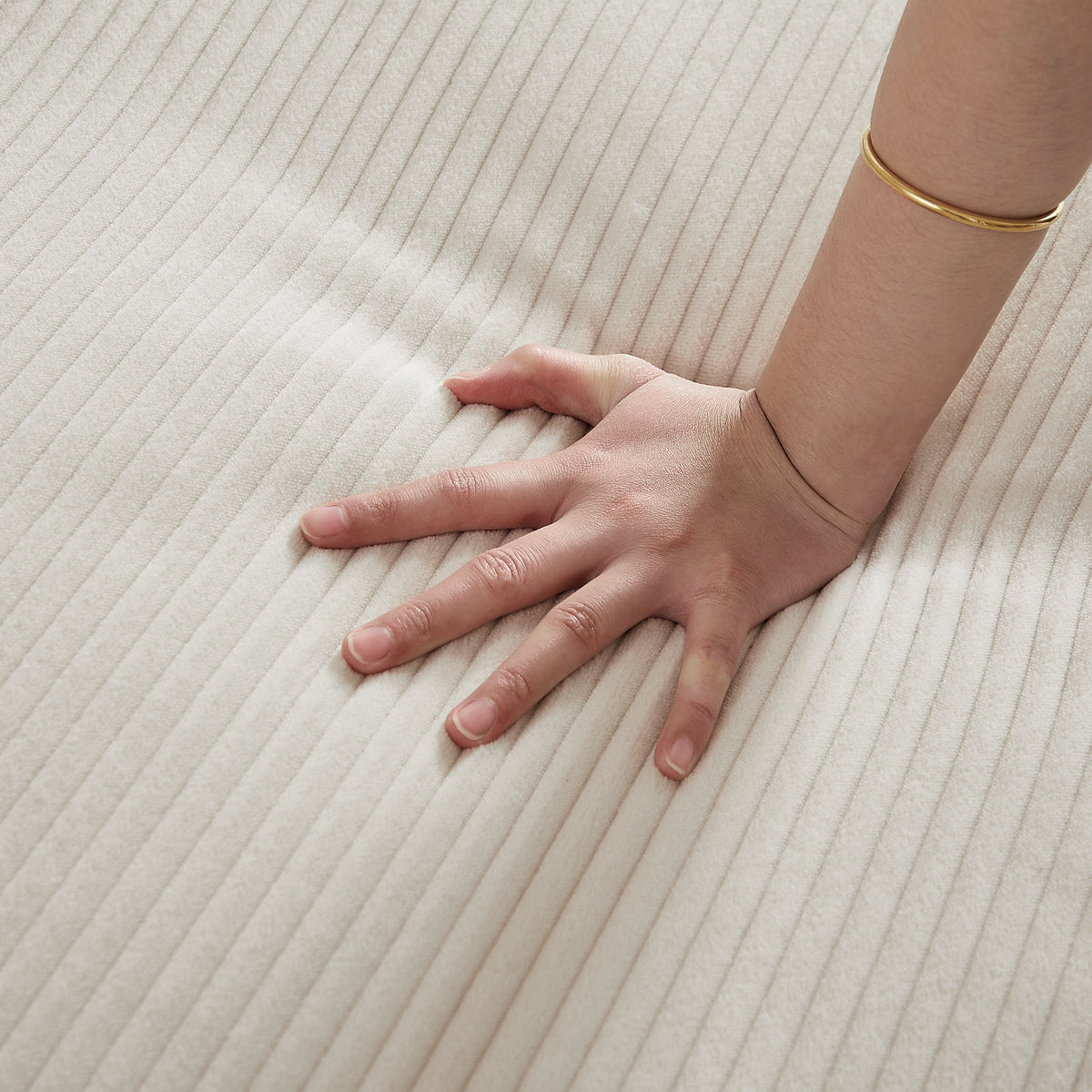 Beige corduroy fabric close-up with a wrist wearing a gold bracelet on Tampa Home & Garden Store