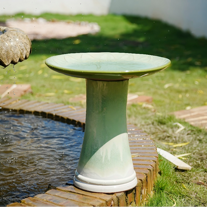 Handmade glazed ceramic bird bath with daisy-petal embossed tray on green pedestal on Tampa Home & Garden Store