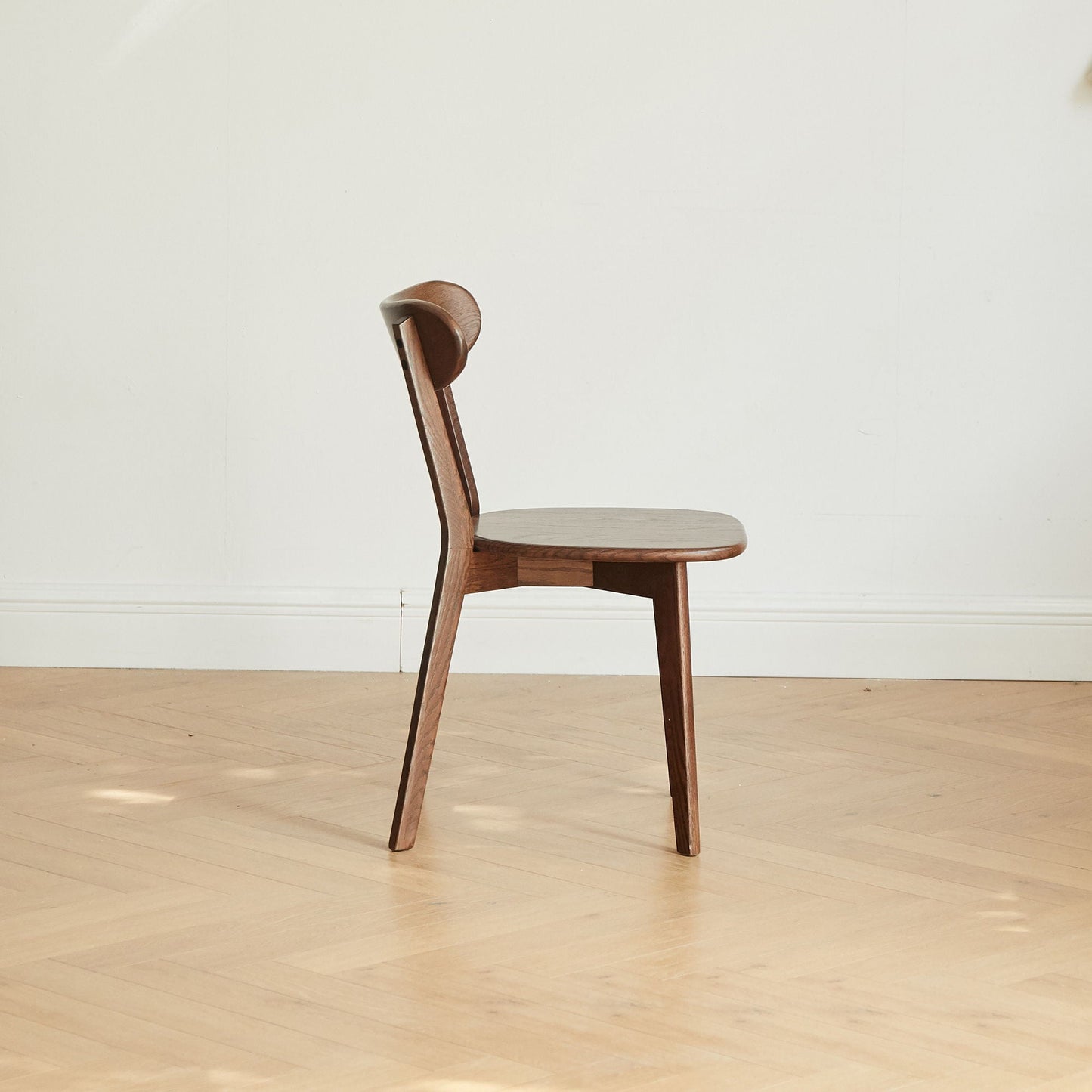 Simple dining chair in solid wood with curved backrest and brown finish on Tampa Home & Garden Store