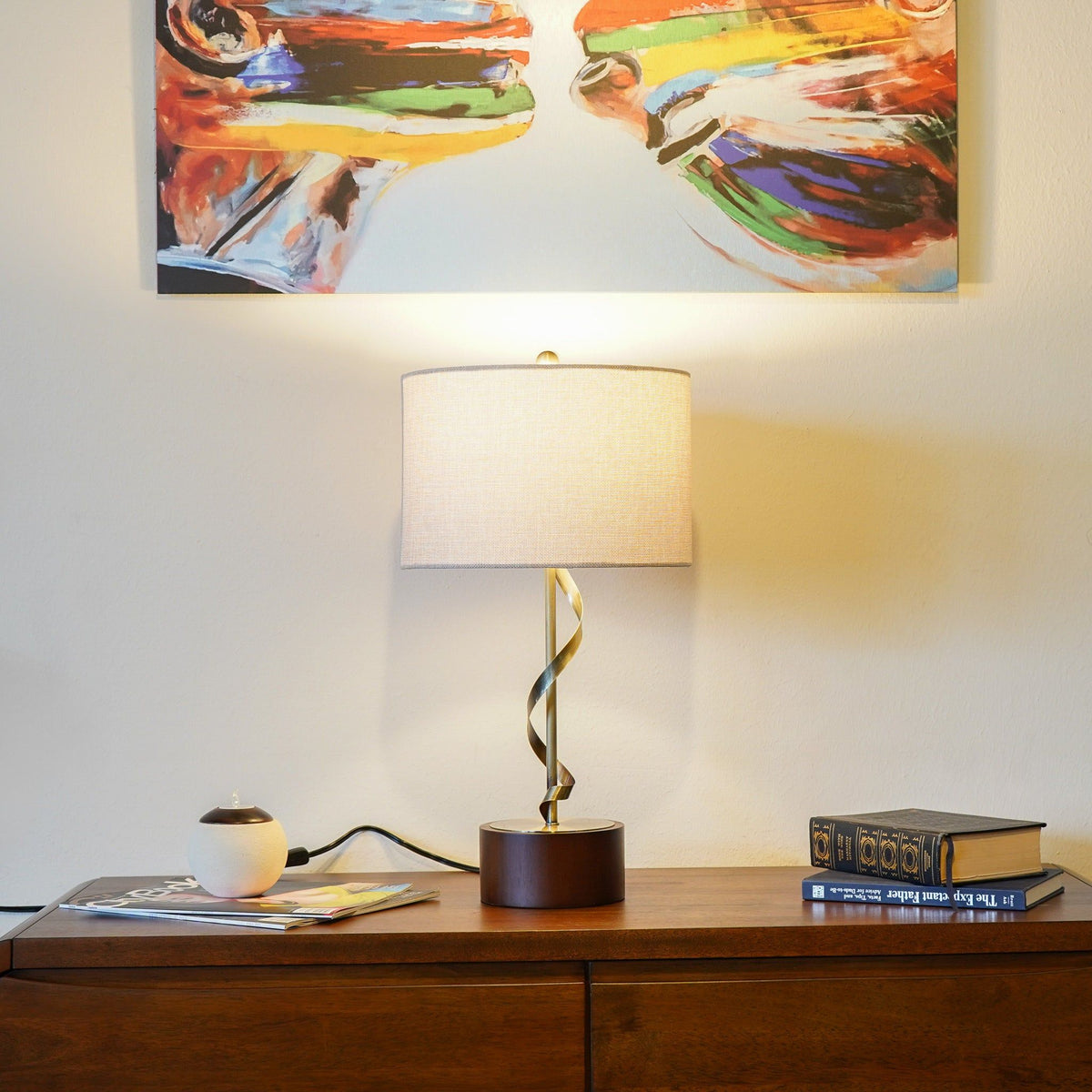 Nightstand lamp with twisted base and white drum shade on wooden dresser on Tampa Home & Garden Store