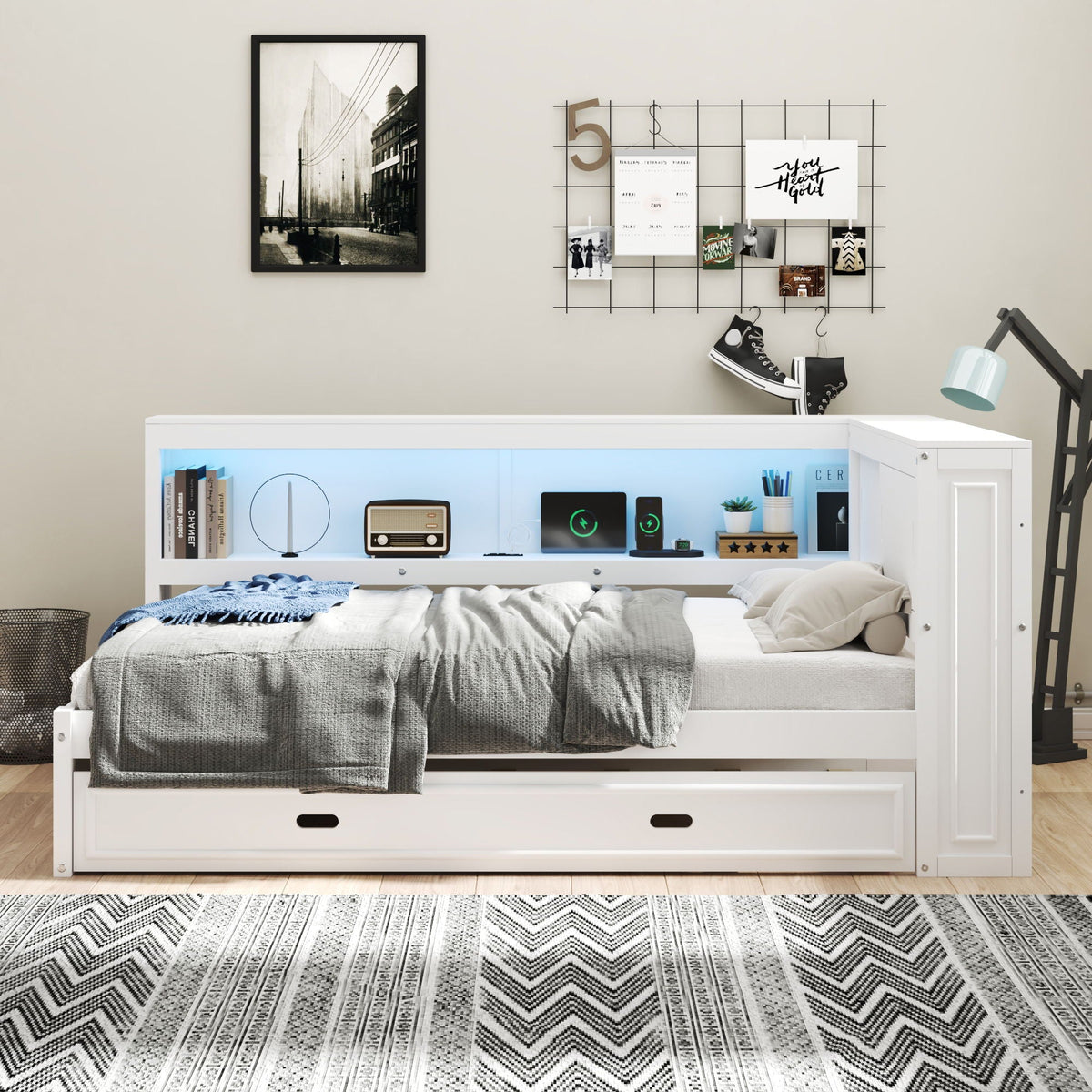 White daybed with under-bed storage drawer, gray bedding, wall-grid display, and desk lamp on Tampa Home & Garden Store