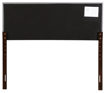 Upholstered black headboard with dark wood legs and back label on Tampa Home & Garden Store