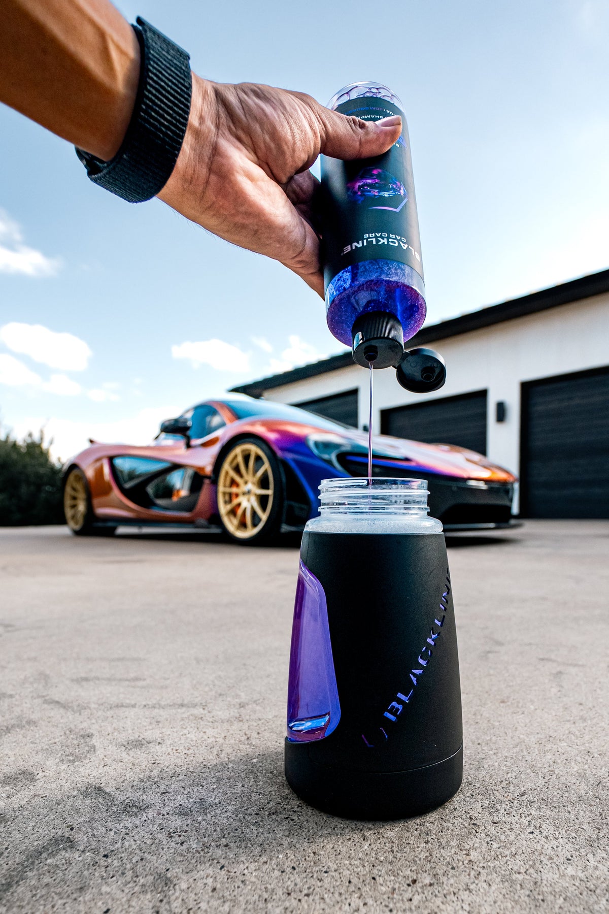 BLACKLINE Ultra Series Foam Cannon bottle with purple body and black cap, outdoors near car on Tampa Home & Garden Store