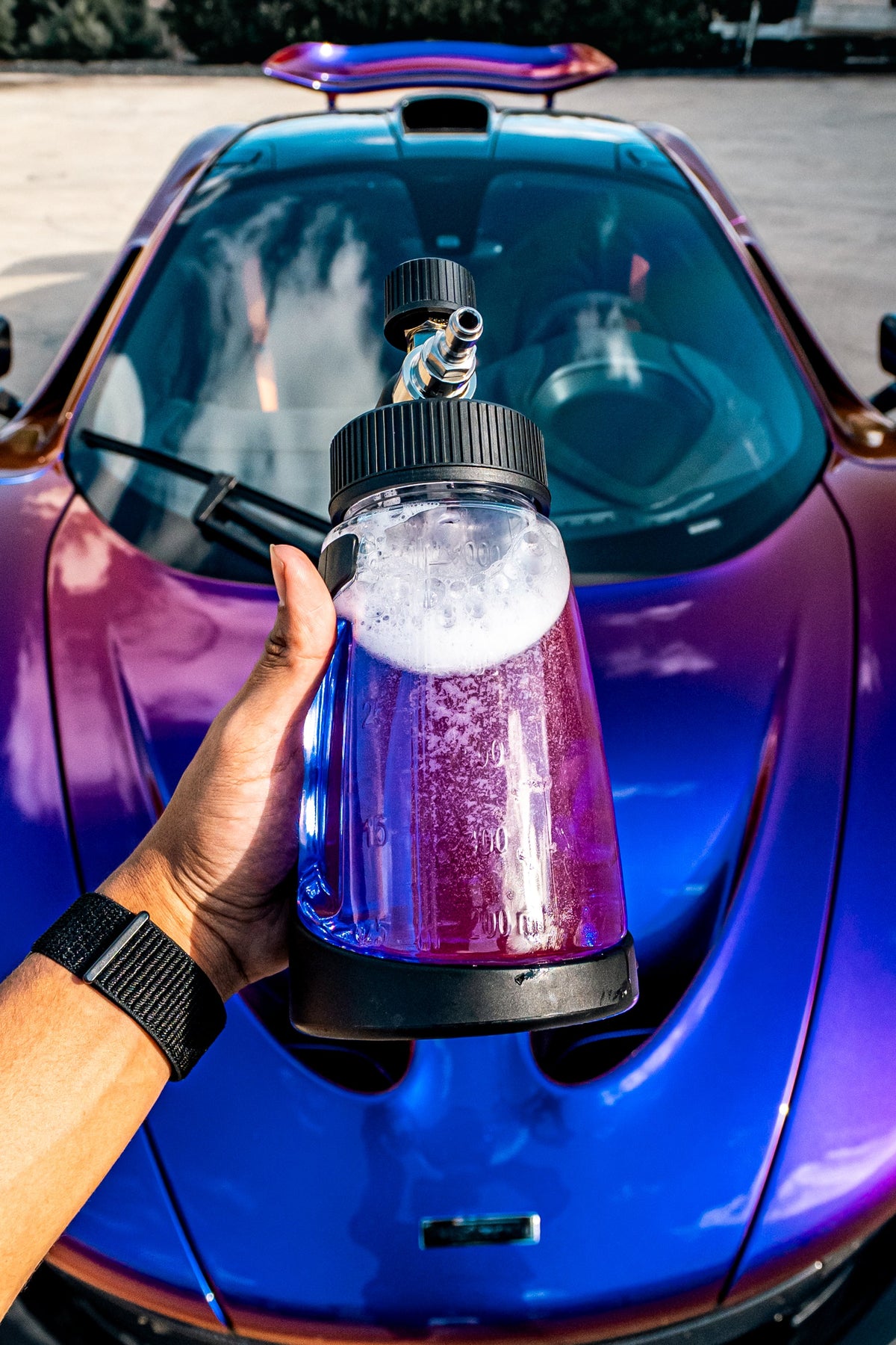 Blackline Ultra Series Foam Cannon in hand with nozzle and purple liquid before a car on Tampa Home & Garden Store