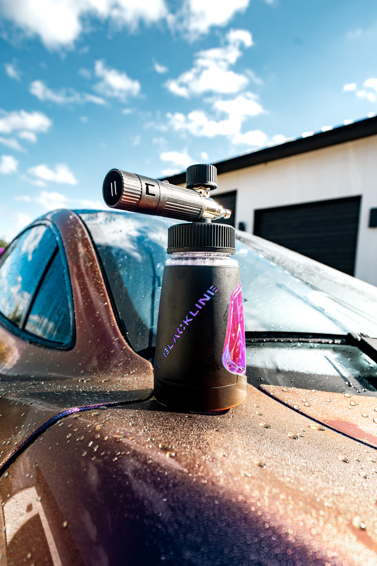 BLACKLINE ULTRA SERIES FOAM CANNON on car hood with black body and purple label on Tampa Home & Garden Store