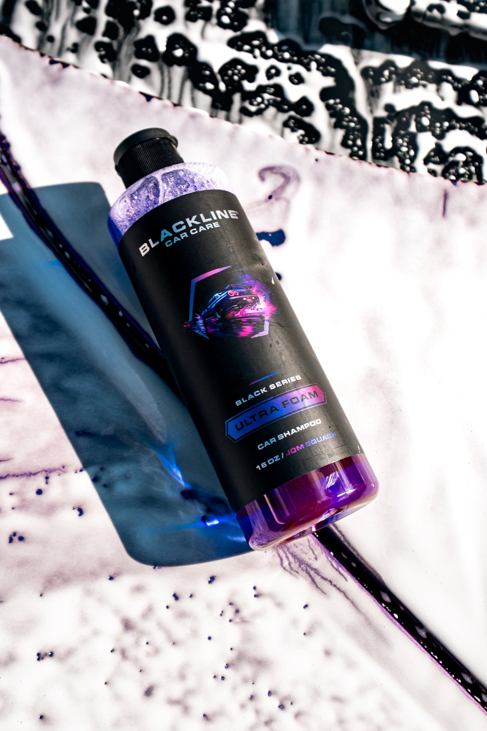 BLACKLINE Ultra Foam car shampoo bottle with purple cap on a soapy surface on Tampa Home & Garden Store