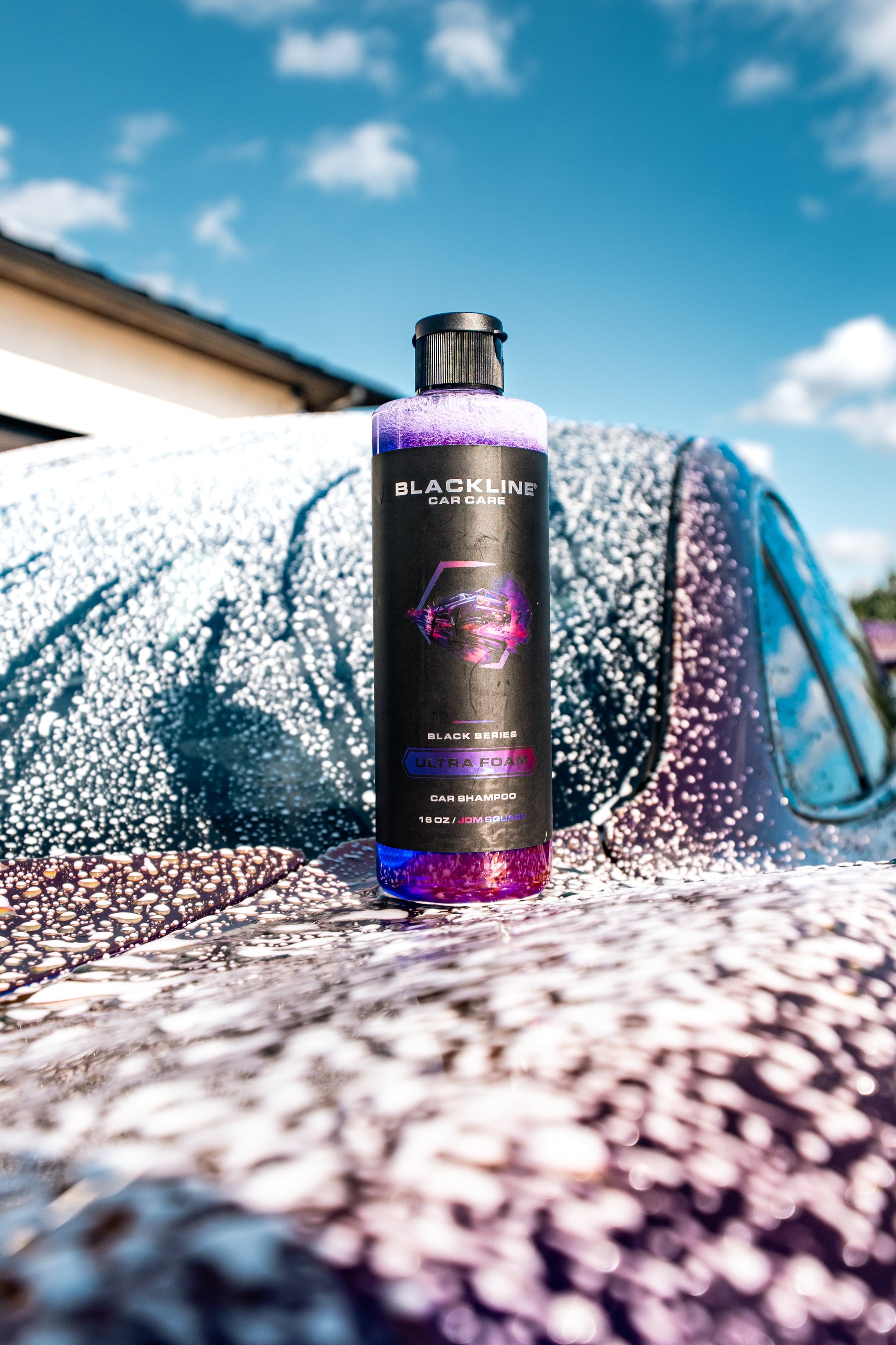 Blackline Car Care Ultra Foam car shampoo bottle with purple liquid on soapy car hood on Tampa Home & Garden Store
