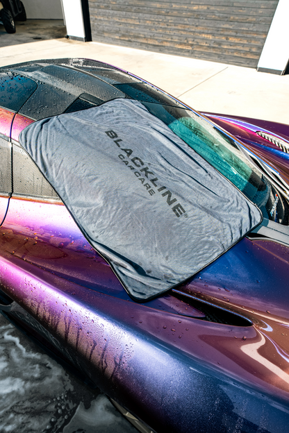BLACKLINE Slim Twisted-Loop Drying Towel draped over a wrapped car with water droplets on Tampa Home & Garden Store