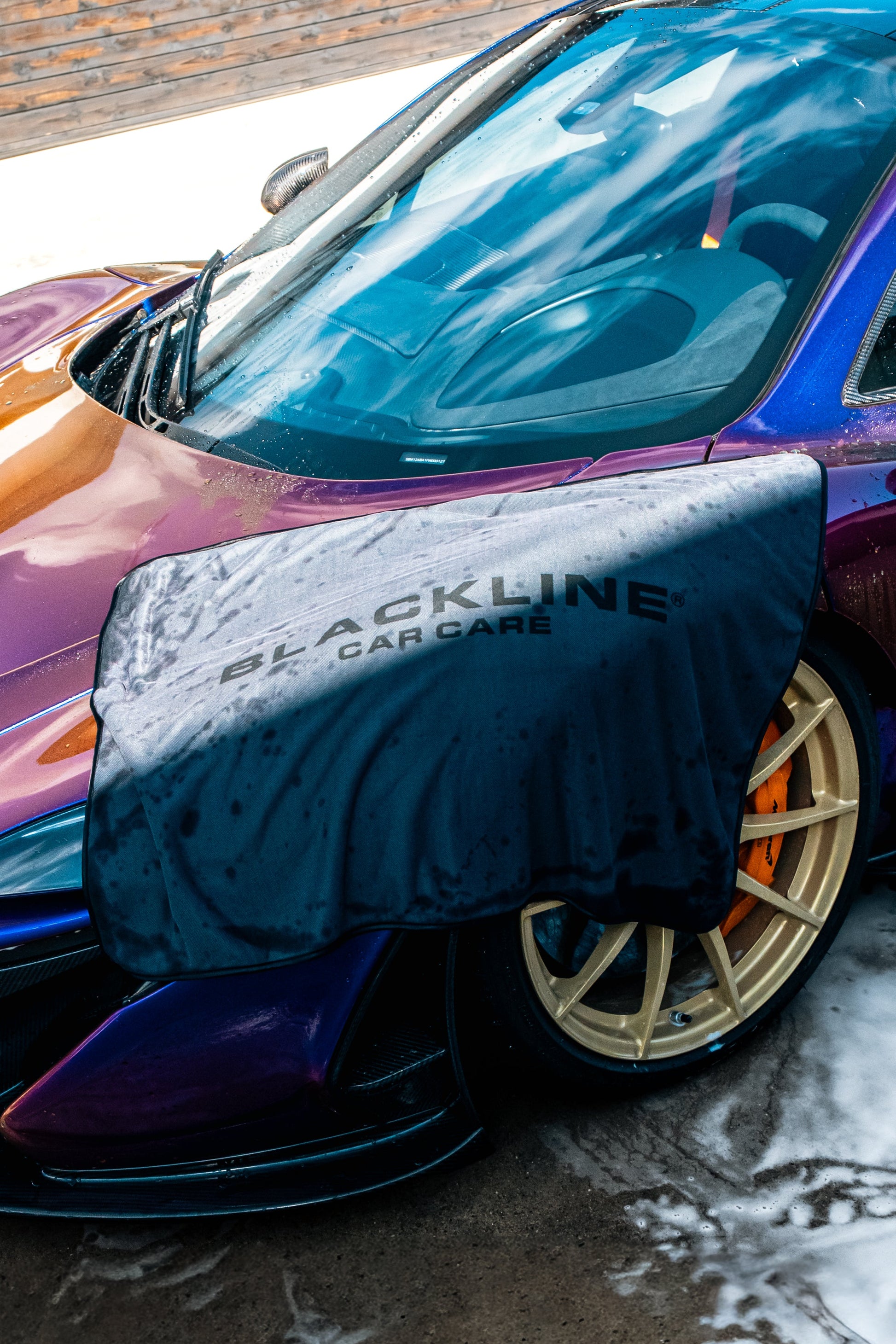 Blackline Car Care Slim Twisted-Loop Drying Towel draped over blue car fender on Tampa Home & Garden Store