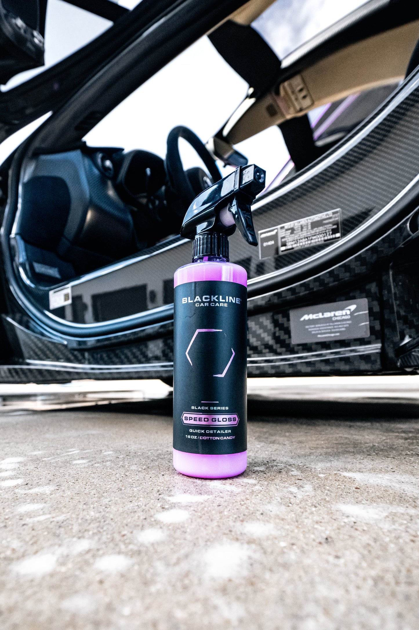 BLACKLINE Speed Gloss Quick Detailer spray bottle, purple bottle, in front of a car interior on Tampa Home & Garden Store