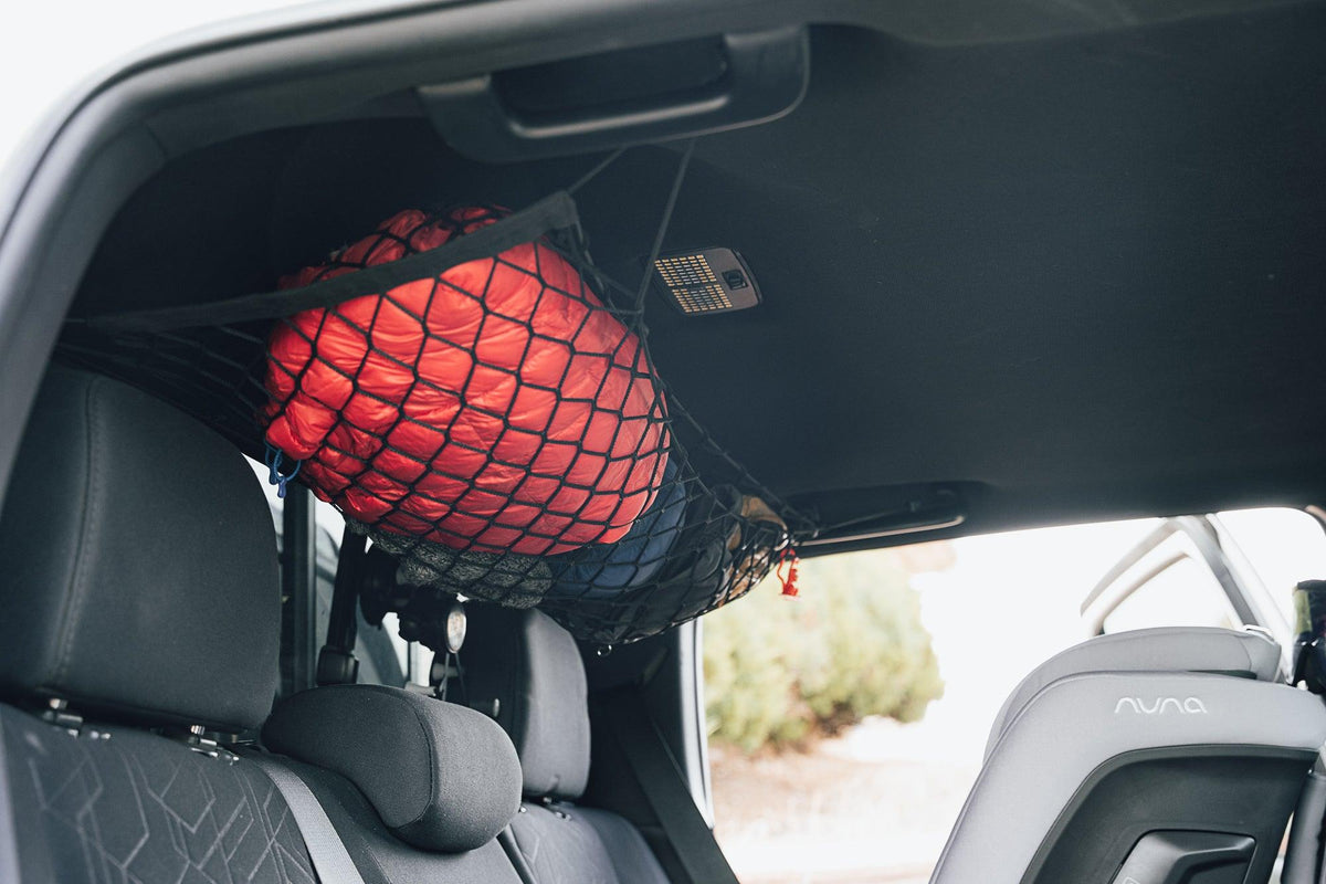 Toyota Tacoma Attic Storage Net black mesh with red bag in rear cargo area on Tampa Home & Garden Store