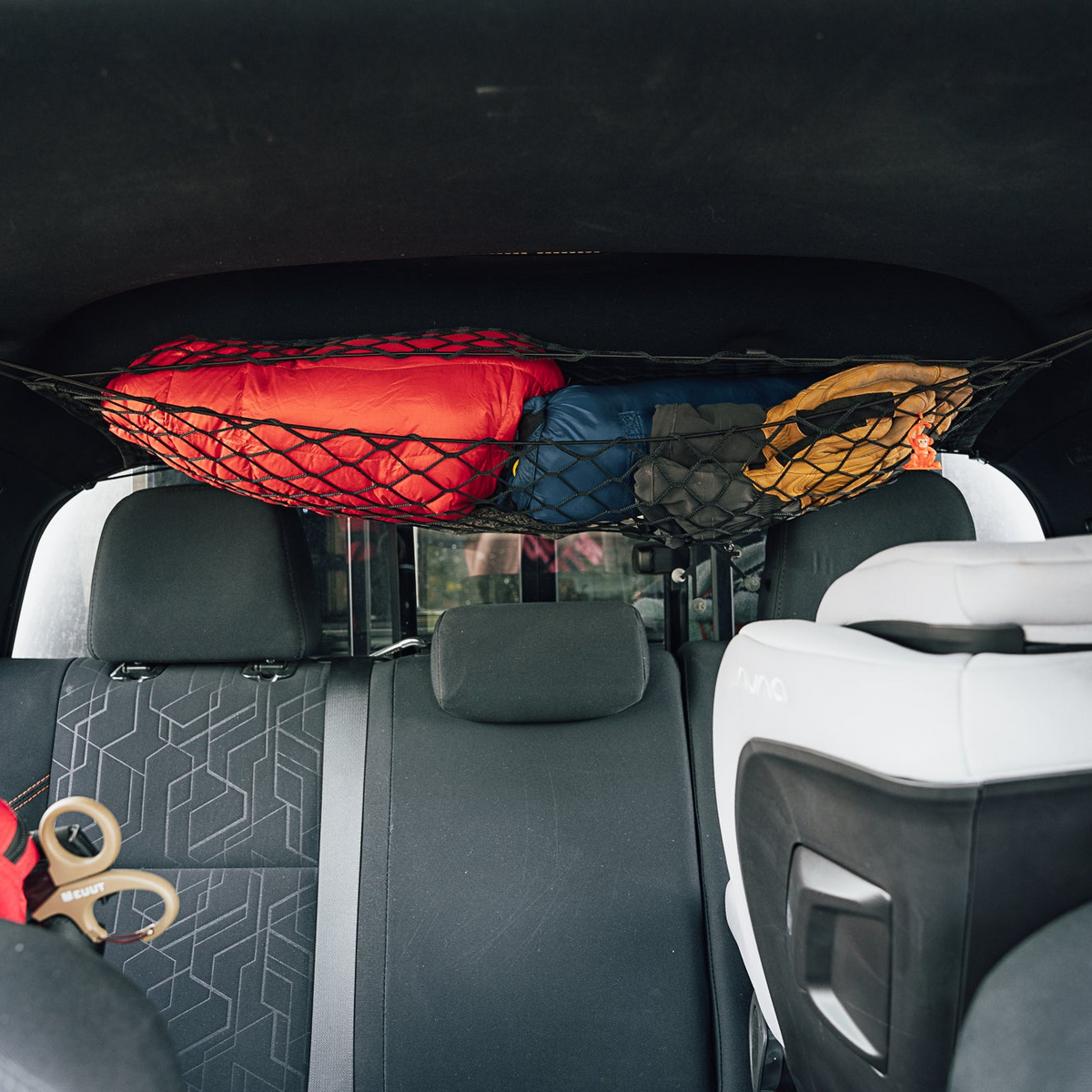 Deluxe Vehicle Organization Bundle cargo nets by Flatirons Overland; red bag, blue pack in car on Tampa Home & Garden Store