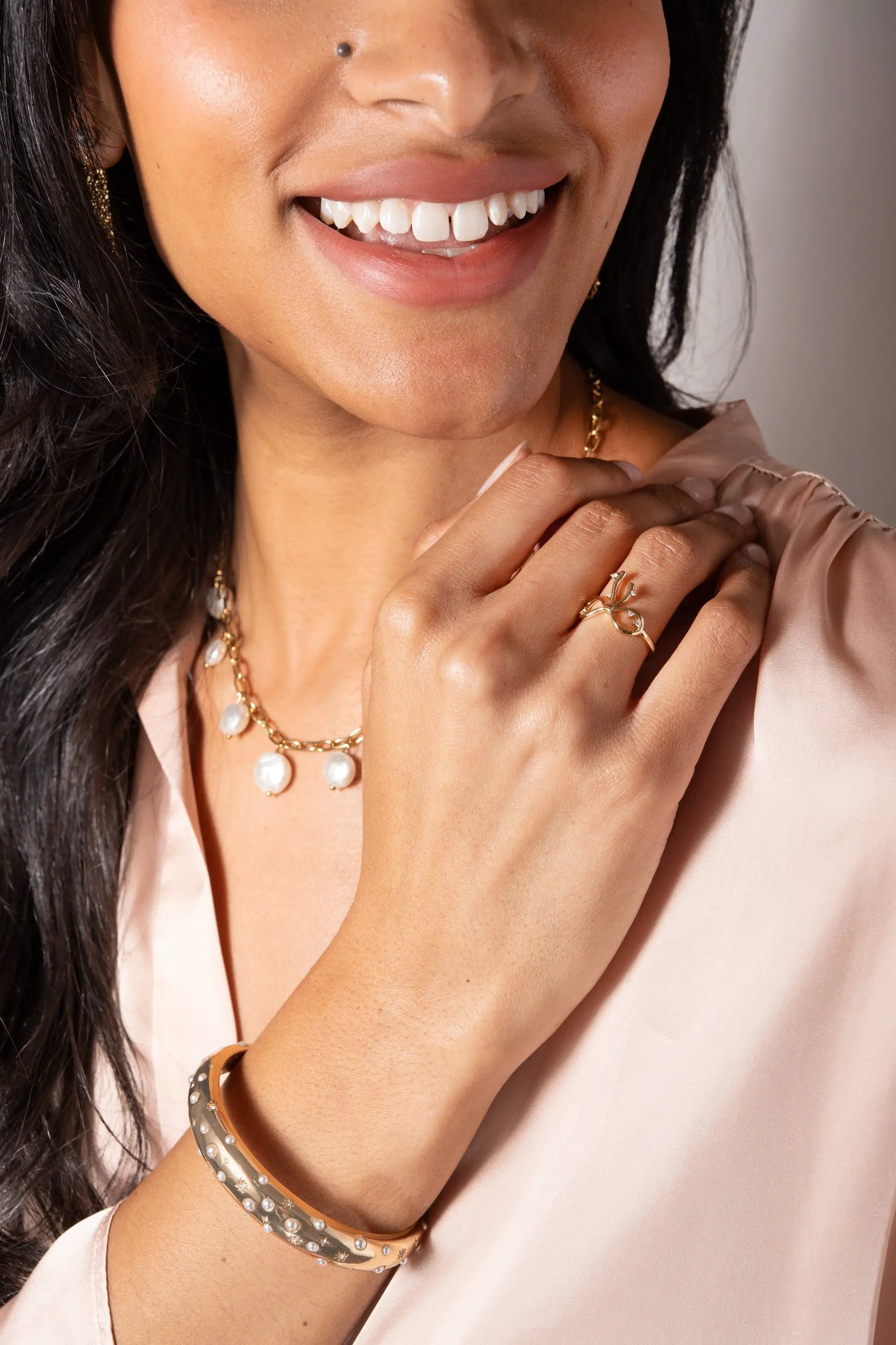 Coquette Bow Ring by ALEX AND ANI, gold-tone bow ring with clear stones worn on finger on Tampa Home & Garden Store