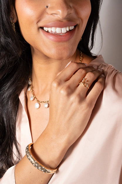 Coquette Bow Ring by ALEX AND ANI, gold-tone bow ring with clear stones worn on finger on Tampa Home & Garden Store