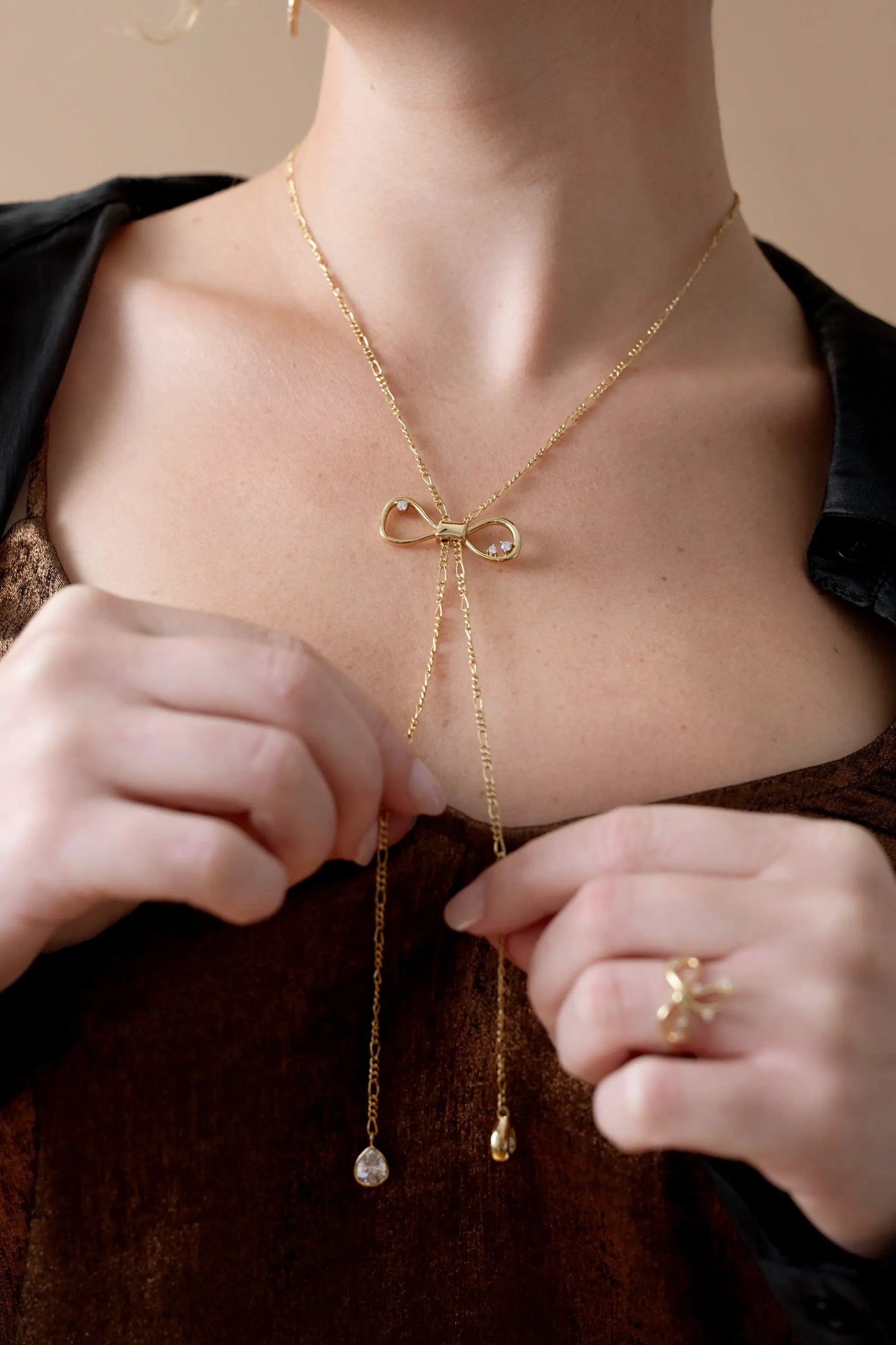 Coquette Bow Necklace gold tone by ALEX AND ANI with crystal bow and tassel drops on Tampa Home & Garden Store