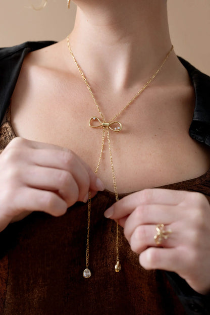 Coquette Bow Necklace gold tone by ALEX AND ANI with crystal bow and tassel drops on Tampa Home & Garden Store
