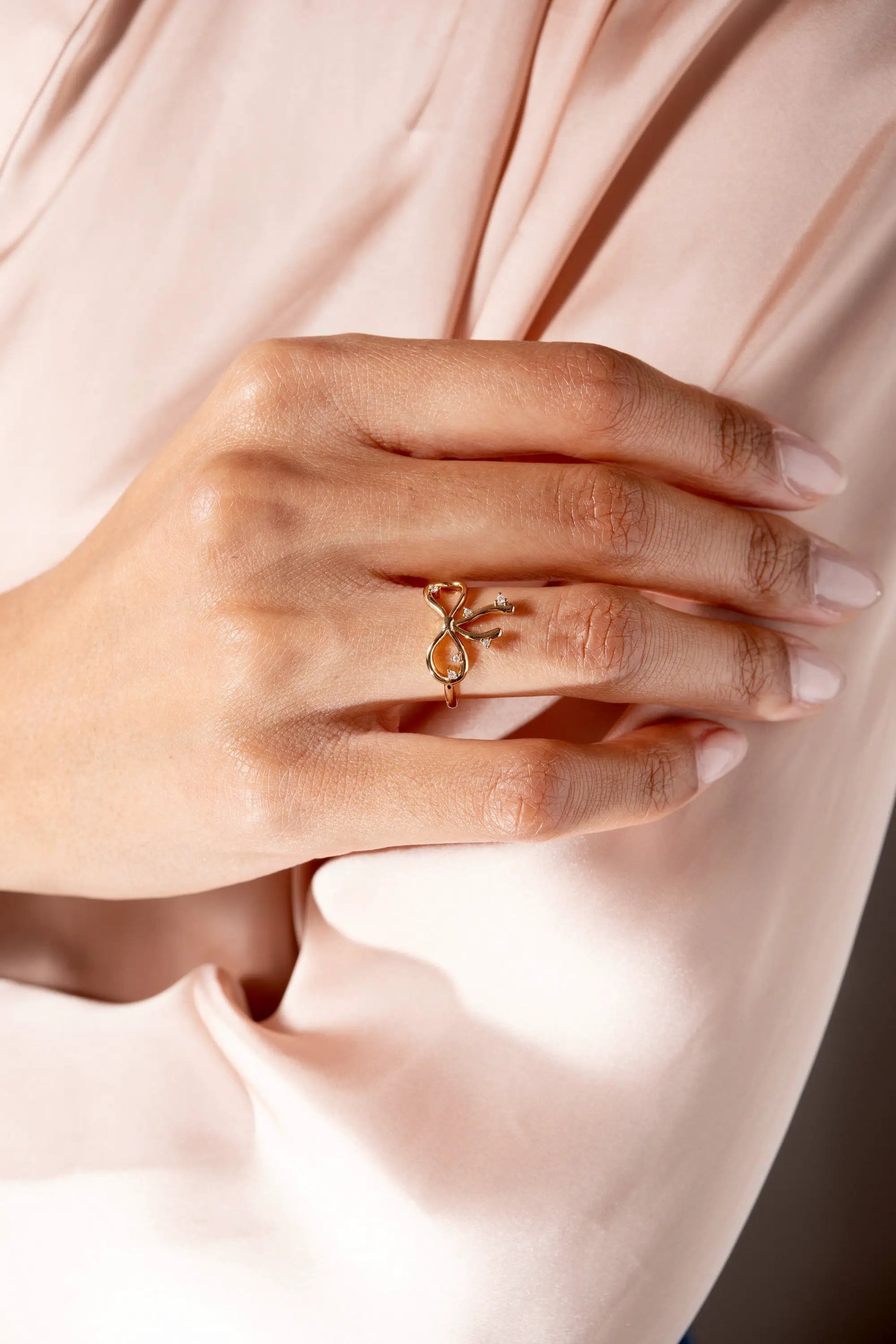 Coquette Bow Ring by Alex and Ani, rose gold tone with delicate bow detail on finger on Tampa Home & Garden Store