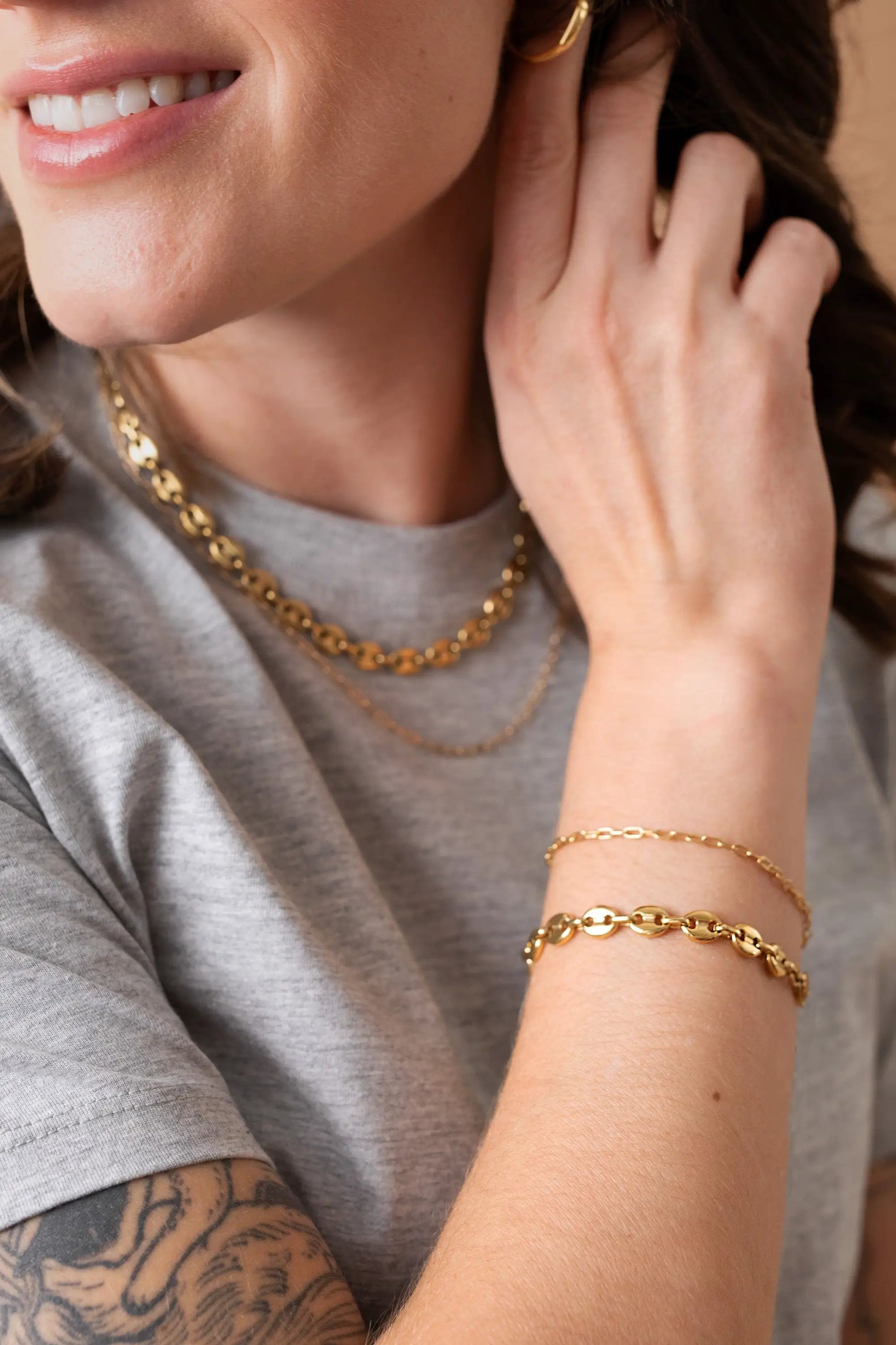 Mariner Necklace gold-tone chain by ALEX AND ANI, shown with layered gold jewelry on a grey tee on Tampa Home & Garden Store