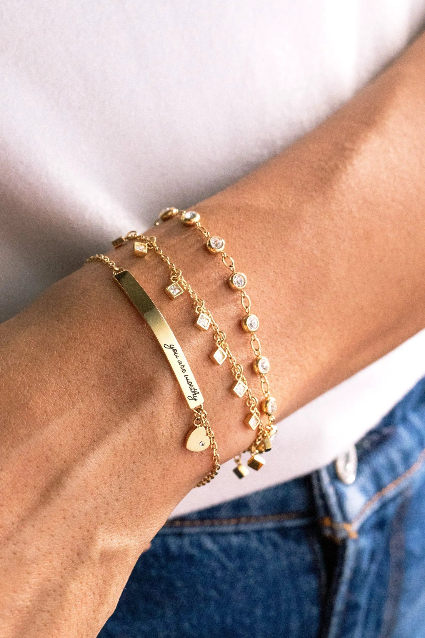 Gold-tone Princess Cut Crystal Bracelet by ALEX AND ANI, layered with crystal charms and a heart charm on Tampa Home & Garden Store