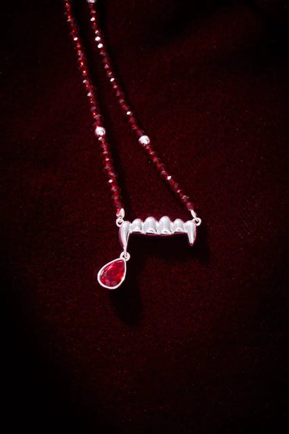 Vampire Teeth Fangs Pendant Necklace with red faceted bead chain and a red teardrop gem on Tampa Home & Garden Store