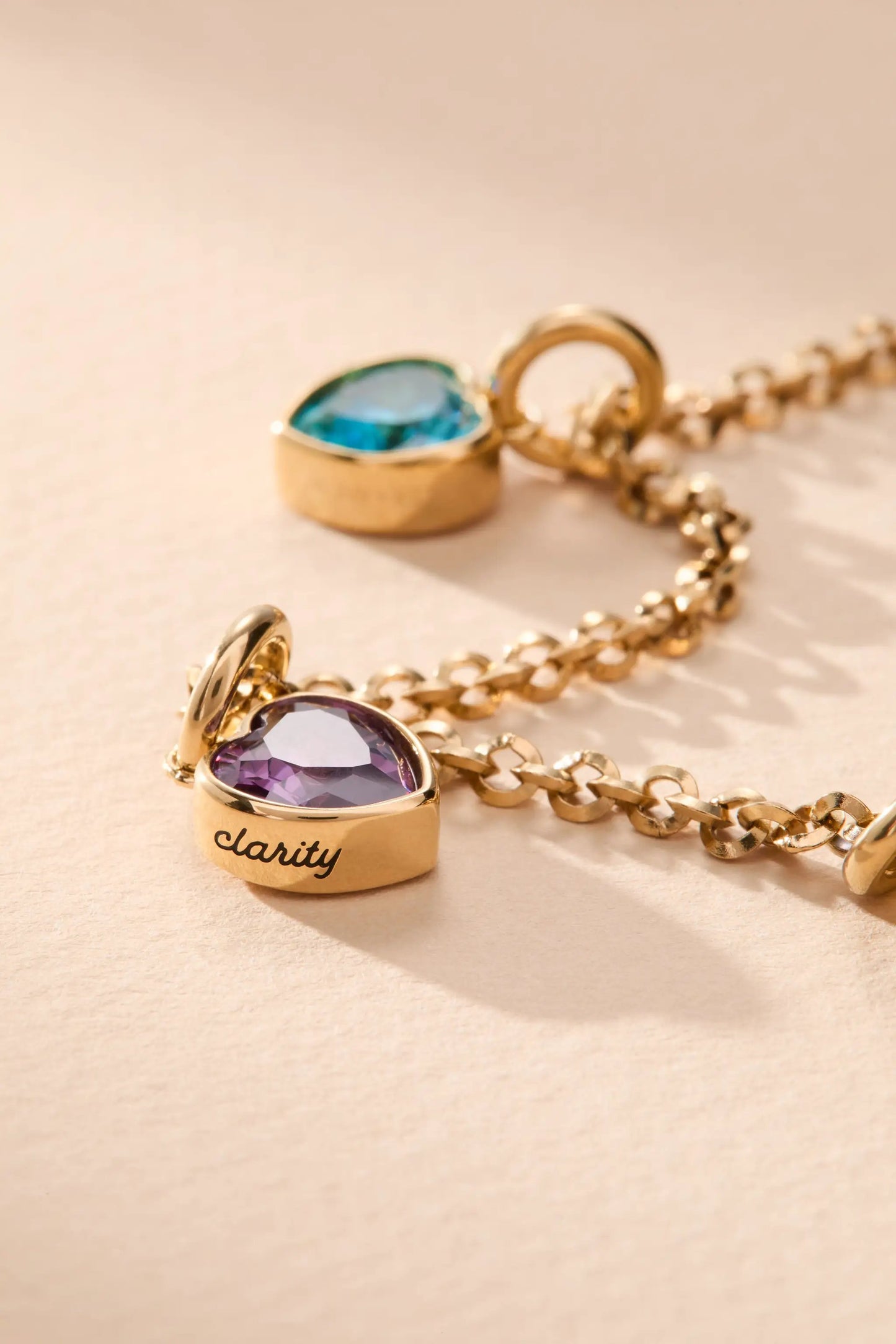 February Clarity Heart Birthstone Charm with two gold-tone gem-heart charms colored on chain on Tampa Home & Garden Store