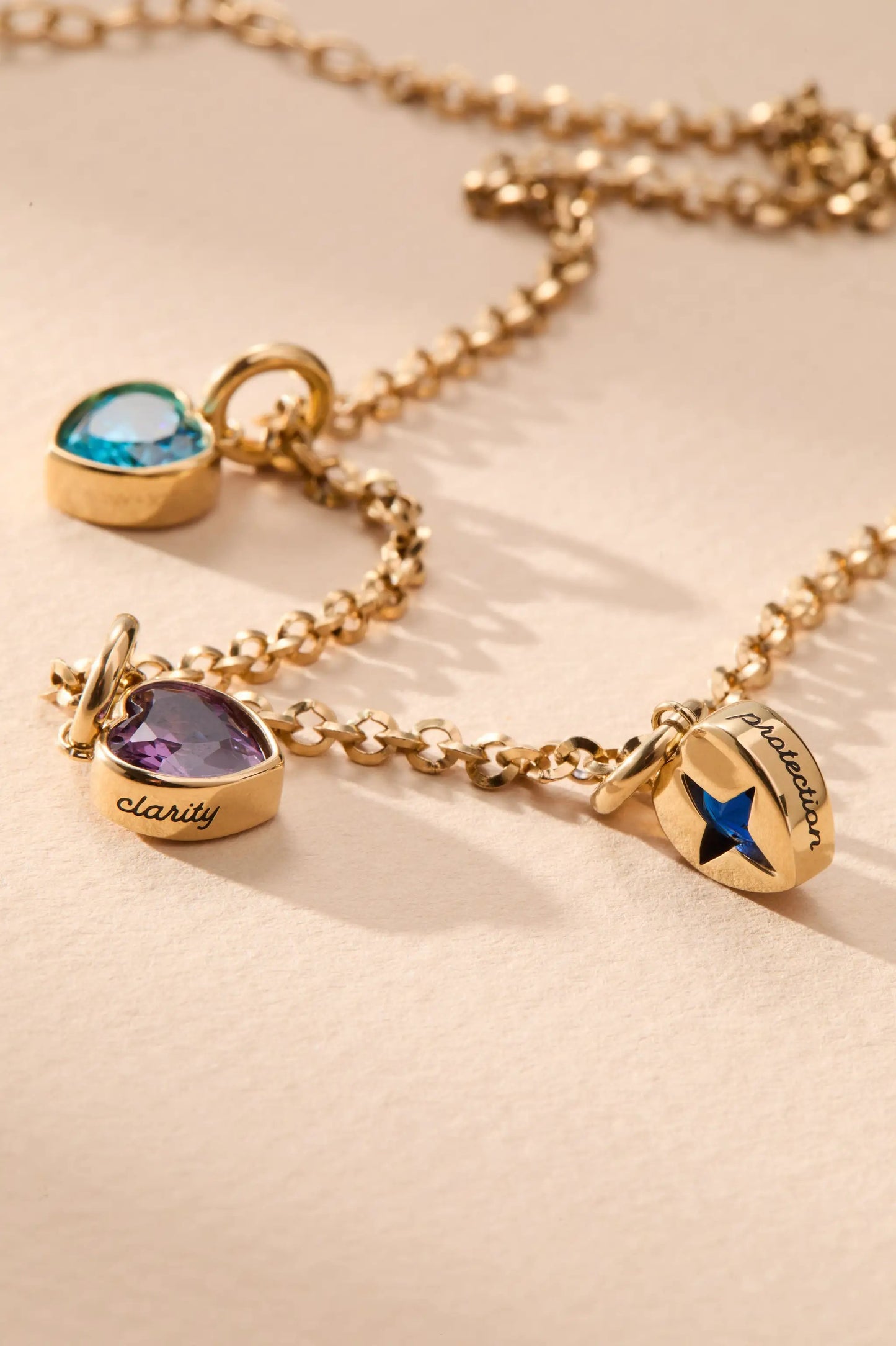 February Clarity Heart Birthstone Charm by Alex and Ani on gold-tone chain with blue gemstone on Tampa Home & Garden Store