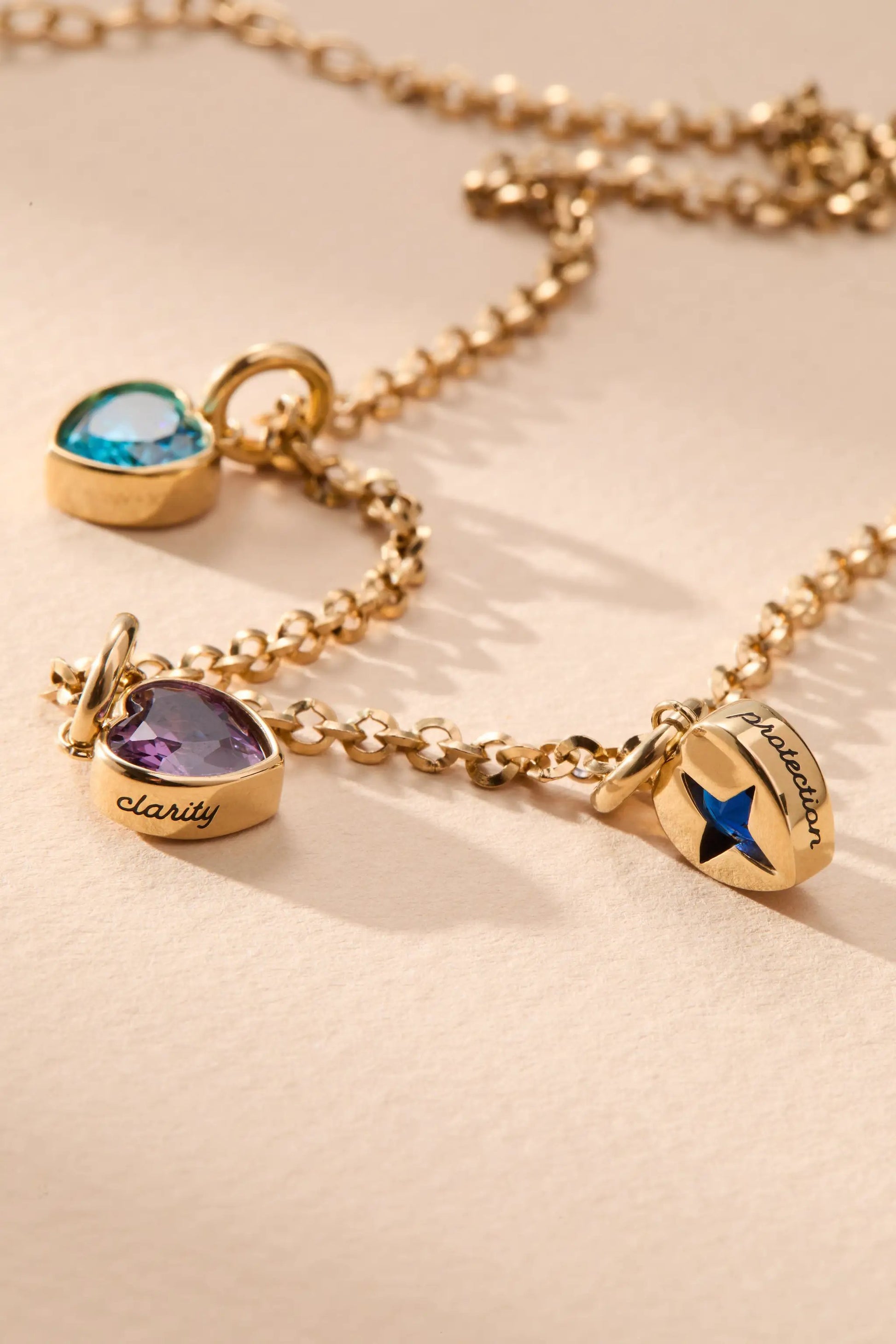 February Clarity Heart Birthstone Charm by Alex and Ani on gold-tone chain with blue gemstone on Tampa Home & Garden Store