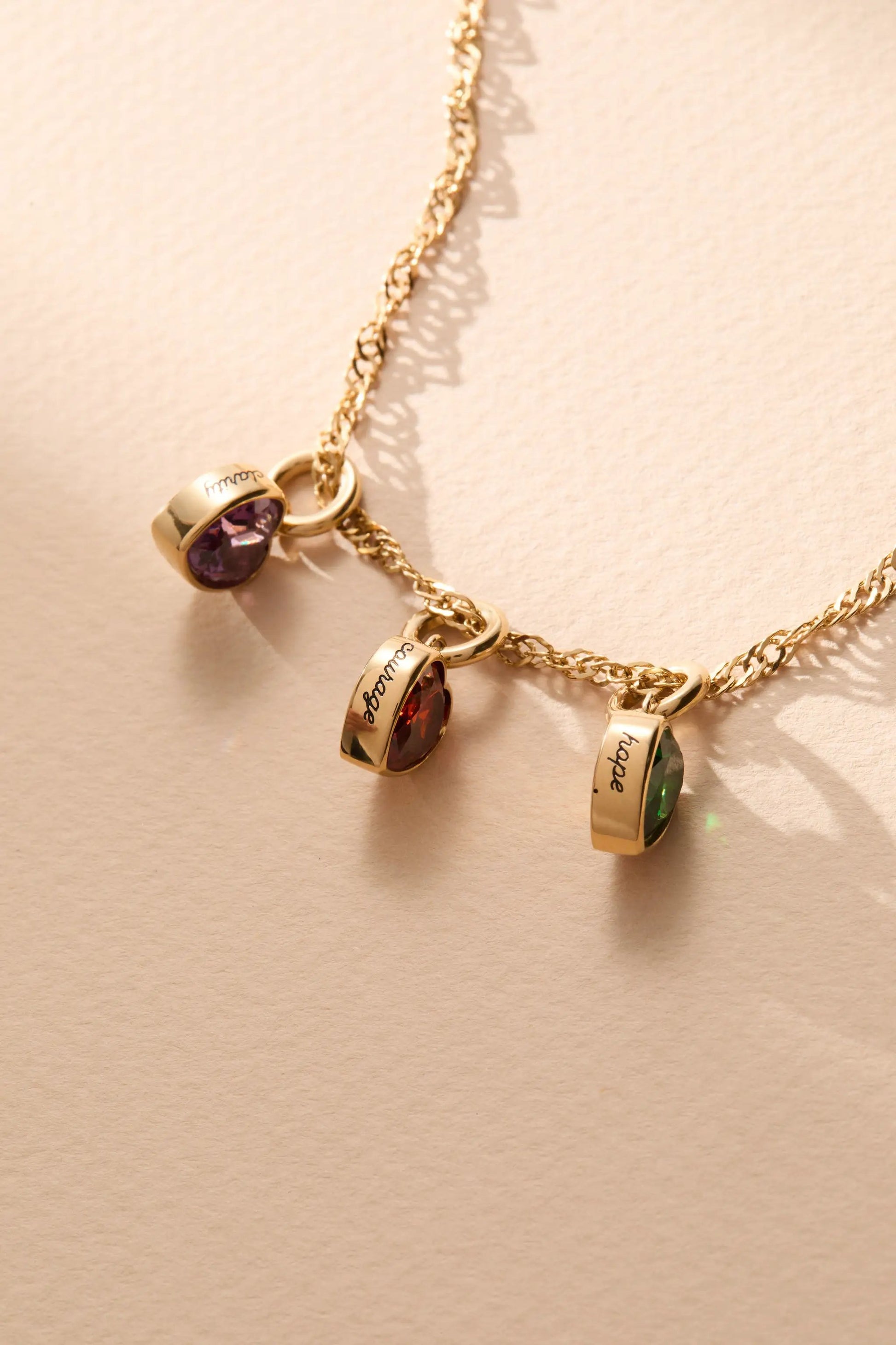 January Courage heart birthstone charms on gold chain with purple and green stones two charms by Alex and Ani on Tampa Home & Garden Store