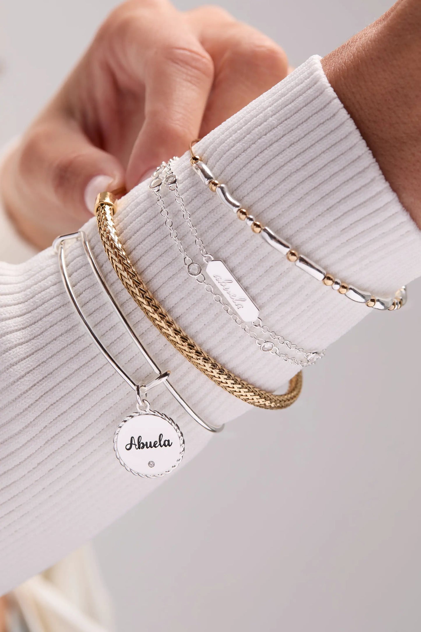 Abuela Infinity Chain Double Strand Bracelet with Abuela charm and gold-tone links stacked on Tampa Home & Garden Store