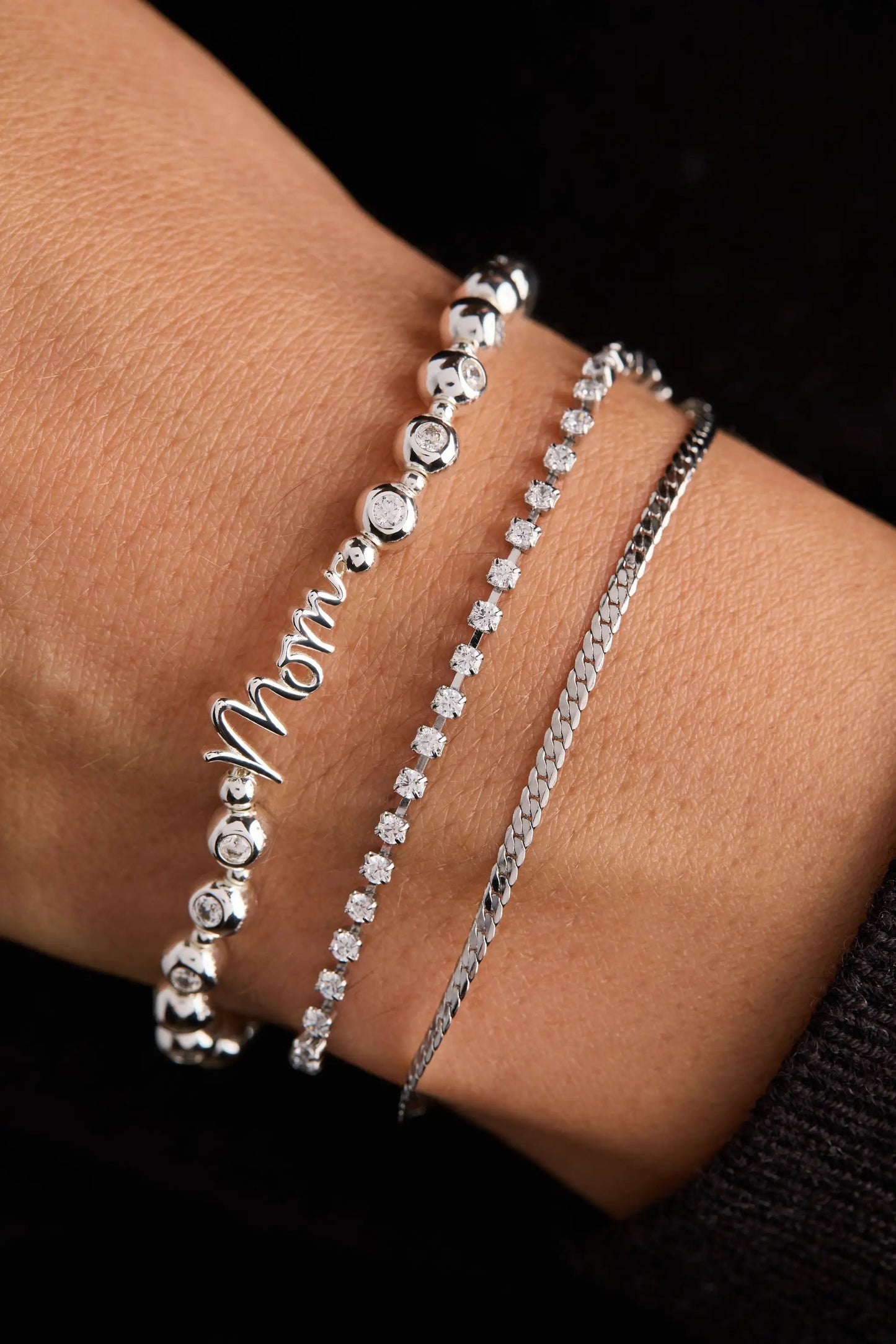 Mom elongated crystal stretch bracelet by Alex and Ani with silver beads, layered with a pavé crystal line and curb-chain bracelet on wrist on Tampa Home & Garden Store